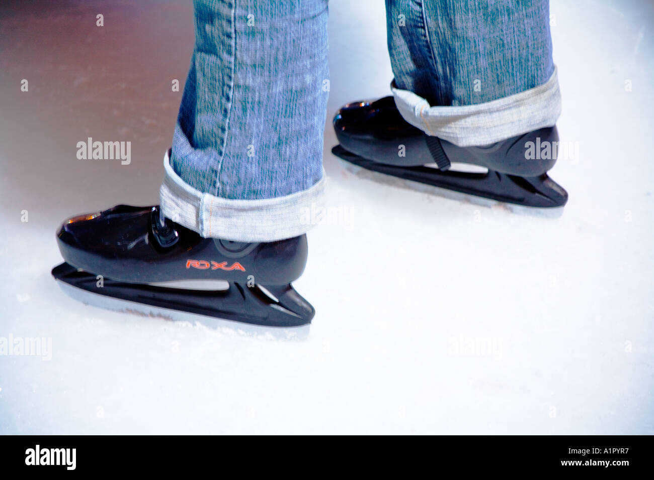 Black ice skating shoes worn on an ice rink. Stock Photo