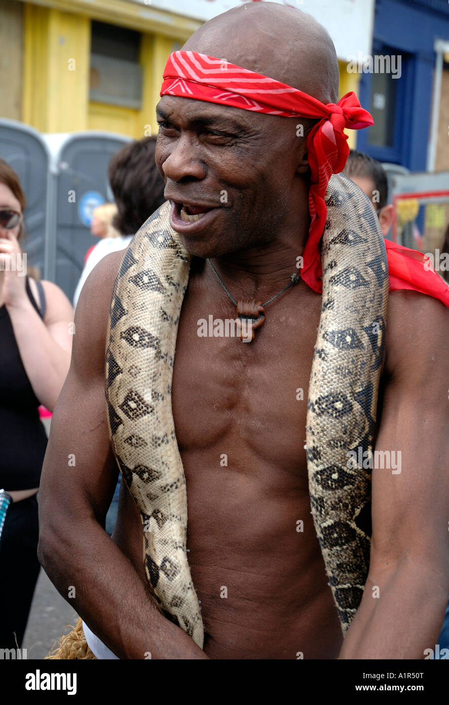 Man with his python in Notting hill carnival Stock Photo - Alamy