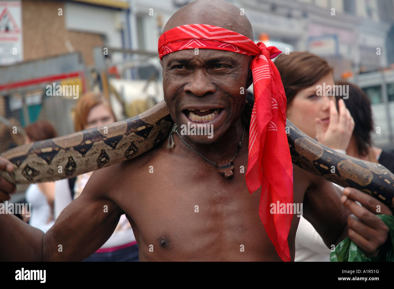 Man with his python in Notting hill carnival.Afro Stock Photo - Alamy
