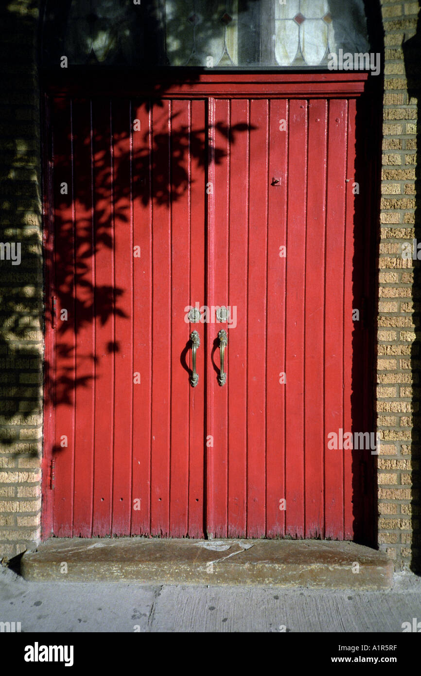 A closed red antique wooden door at late afternoon Stock Photo