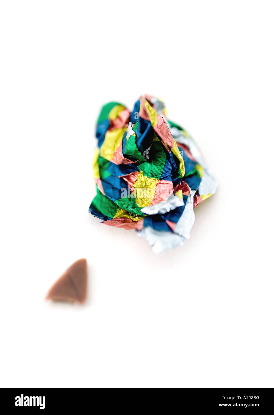 Crumpled candy wrapper and small piece of chocolate Stock Photo - Alamy