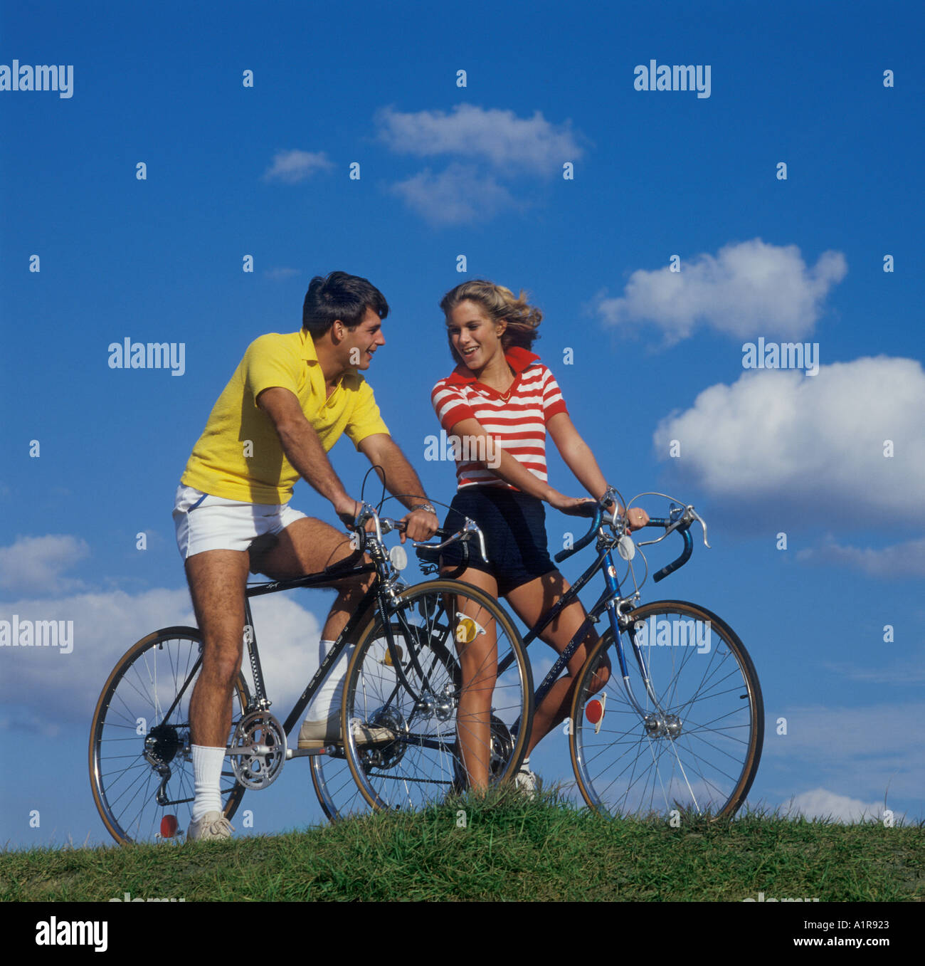 young couple on bicycles Stock Photo