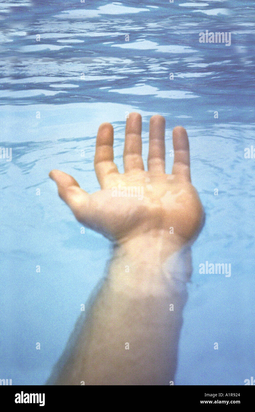 Outstretched Hand Over Water Stock Photo