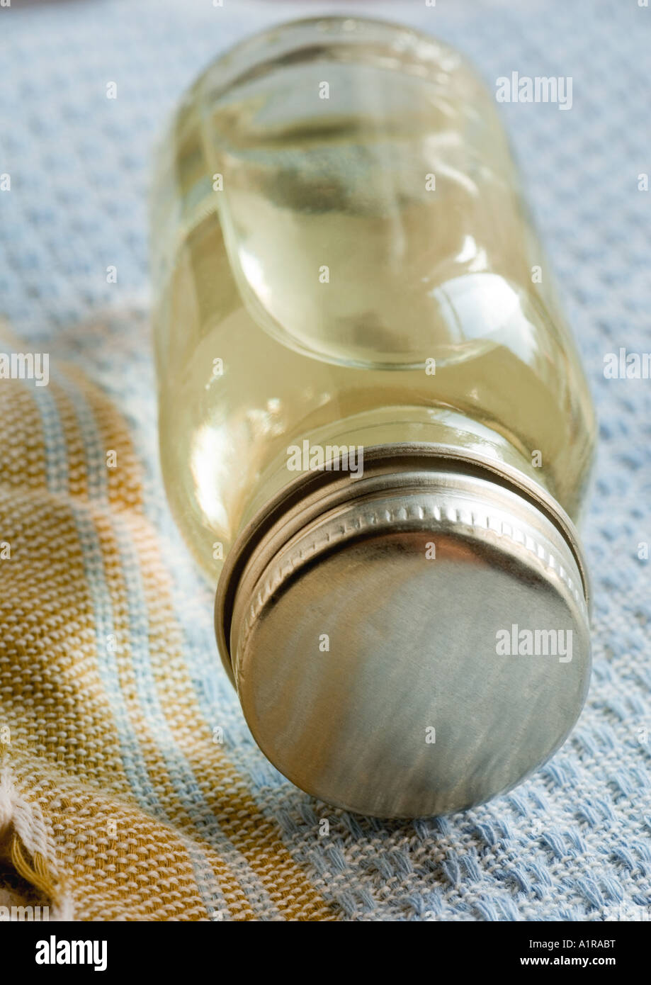 Bottle of essential oil on side, on towel Stock Photo
