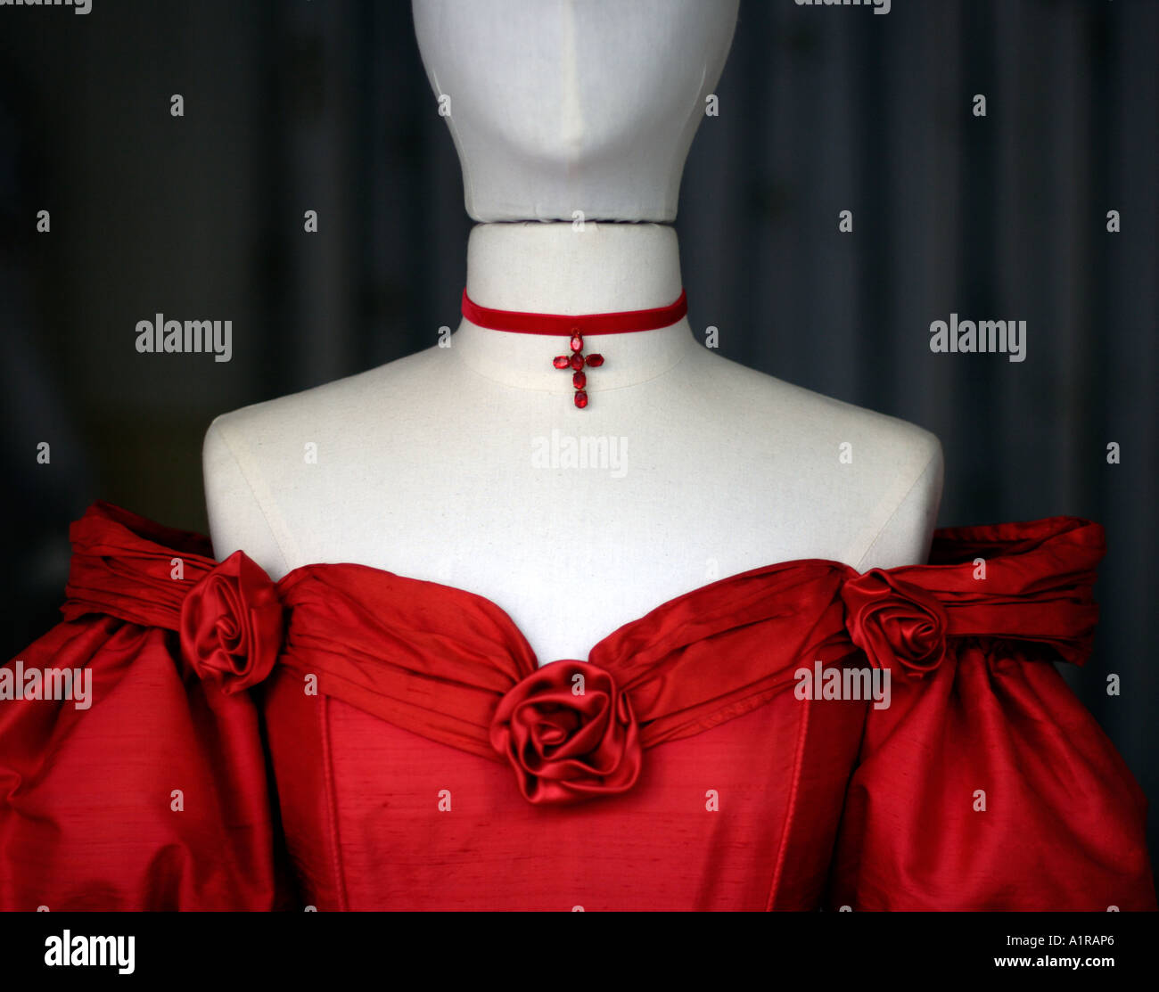 Shop window mannequin wearing strapless red velvet dress Stock Photo
