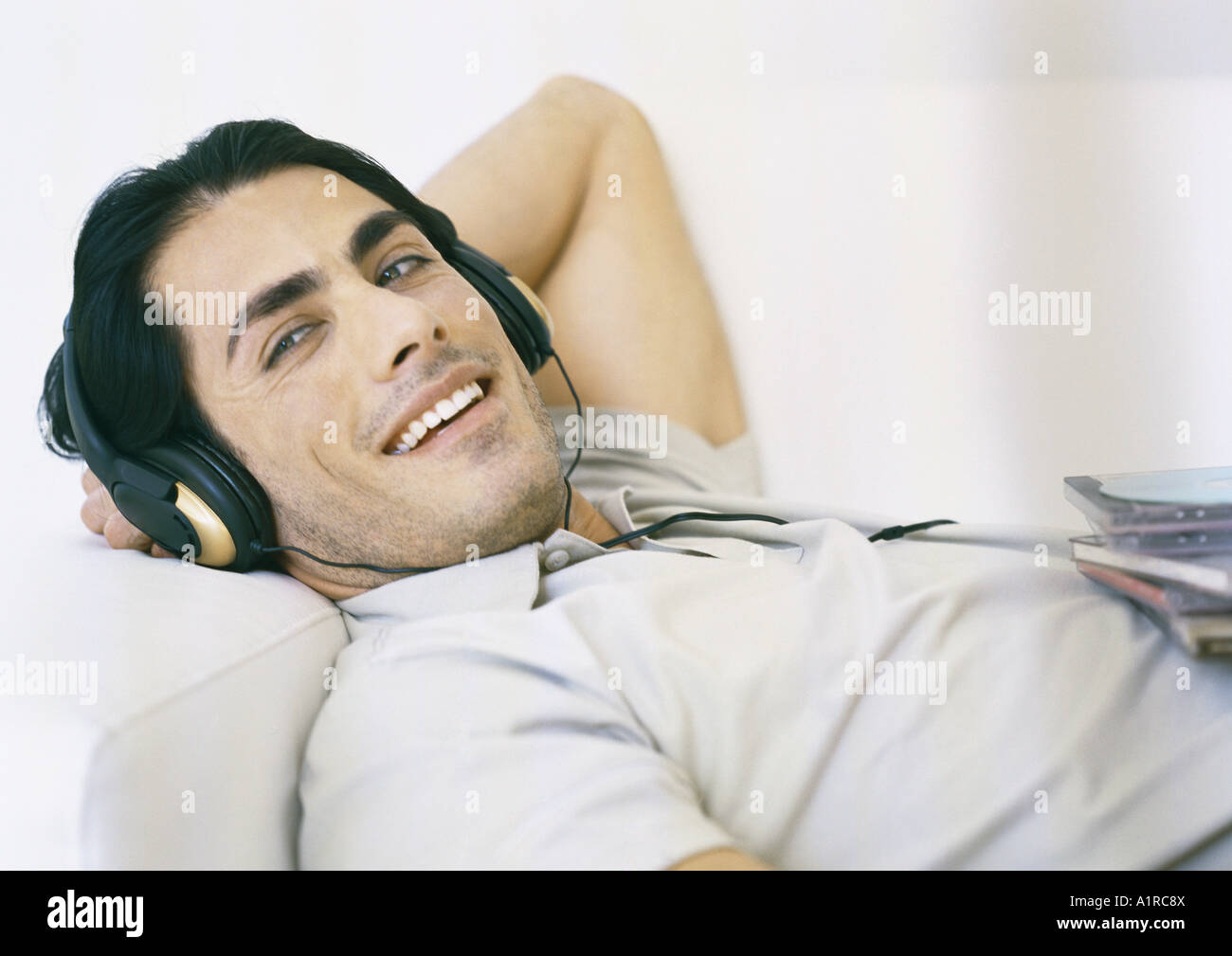 Man listening to headphones Stock Photo - Alamy