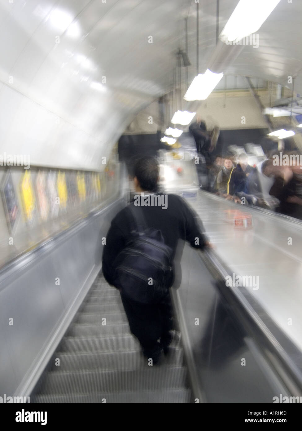 man travelling down an escalator Stock Photo