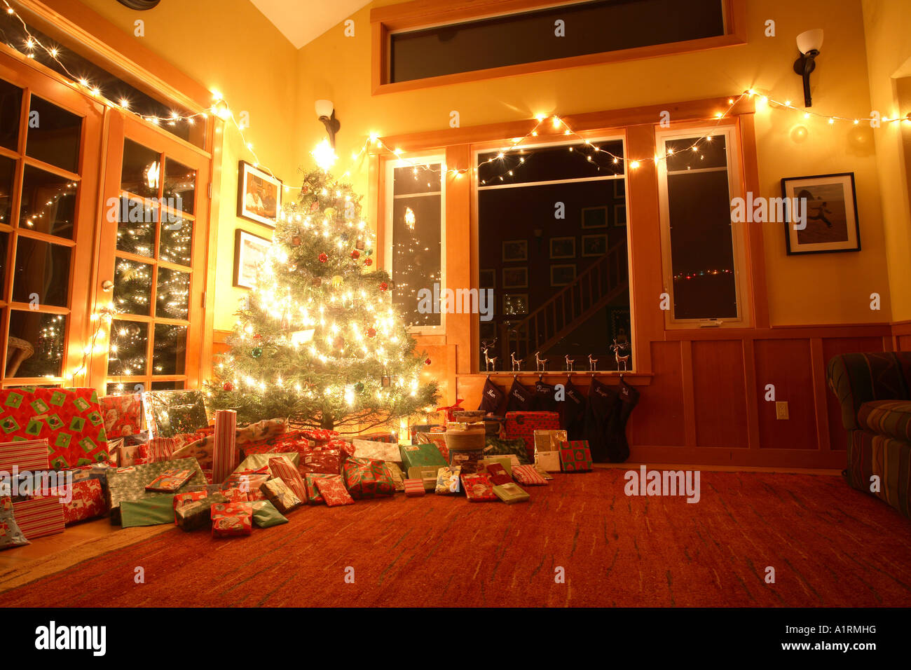 A christmas tree at night with white lights and presents Stock Photo ...
