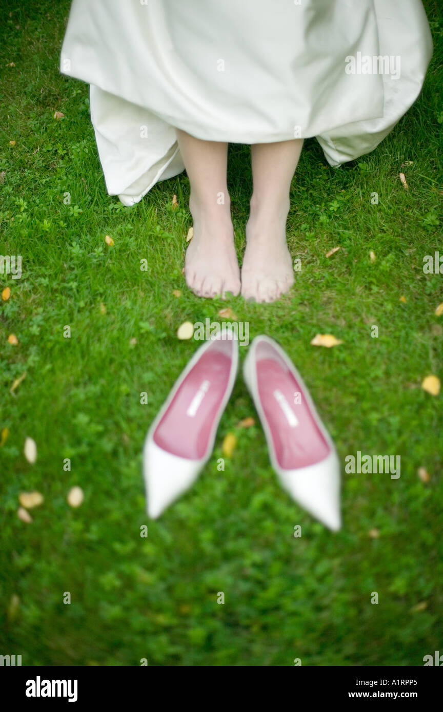 Wedding bride with aching feet because of her shoes Stock Photo