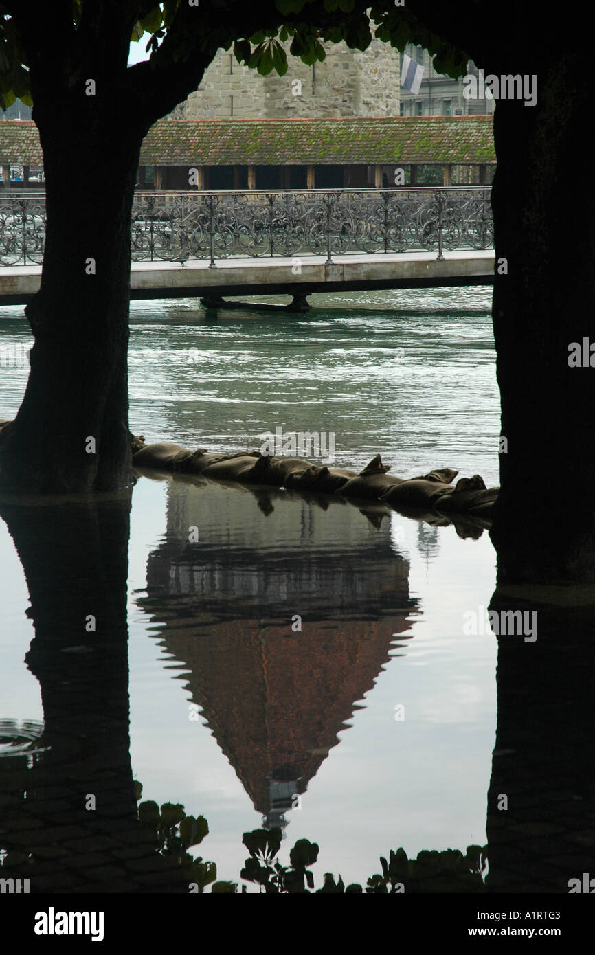 mirror in the water showing water tower, chappel bridge during a flood Stock Photo