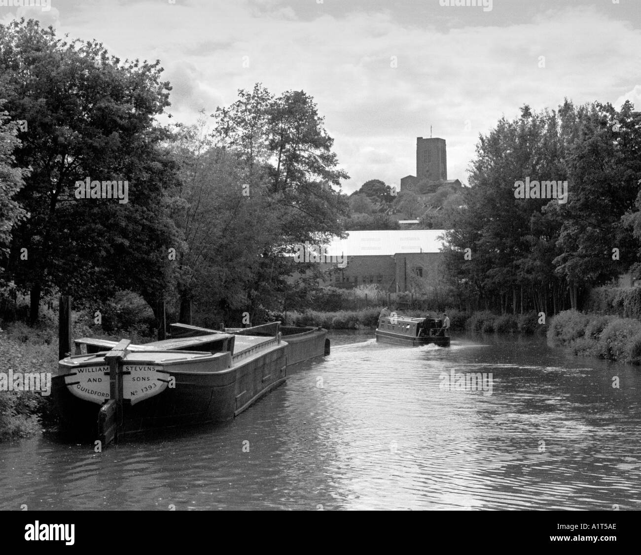 Barge and narrowboat on the Wey Navigation in Guildford, Surrey Stock Photo