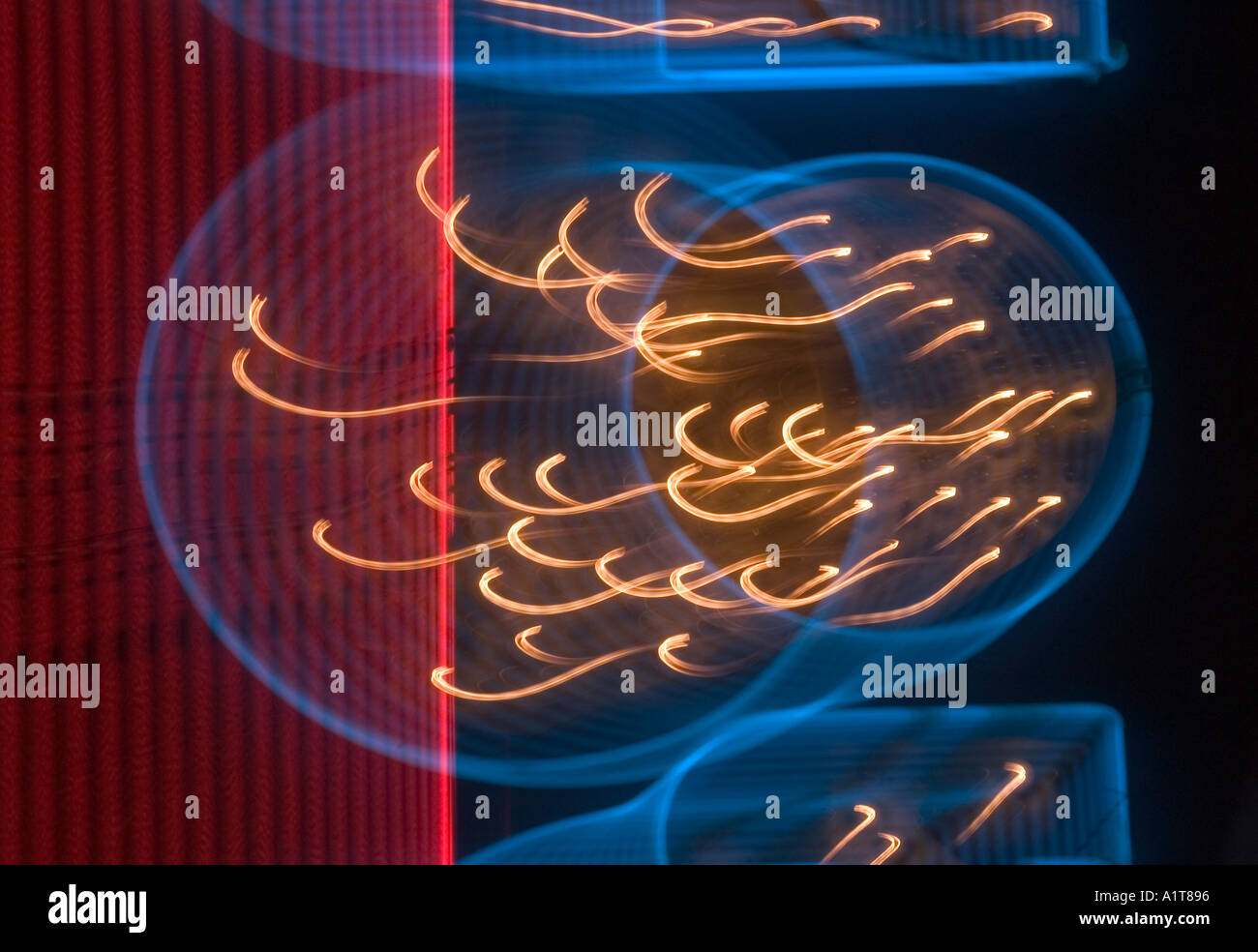 An abstract motion blurred image of a neon sign in blue and red and yellow Stock Photo