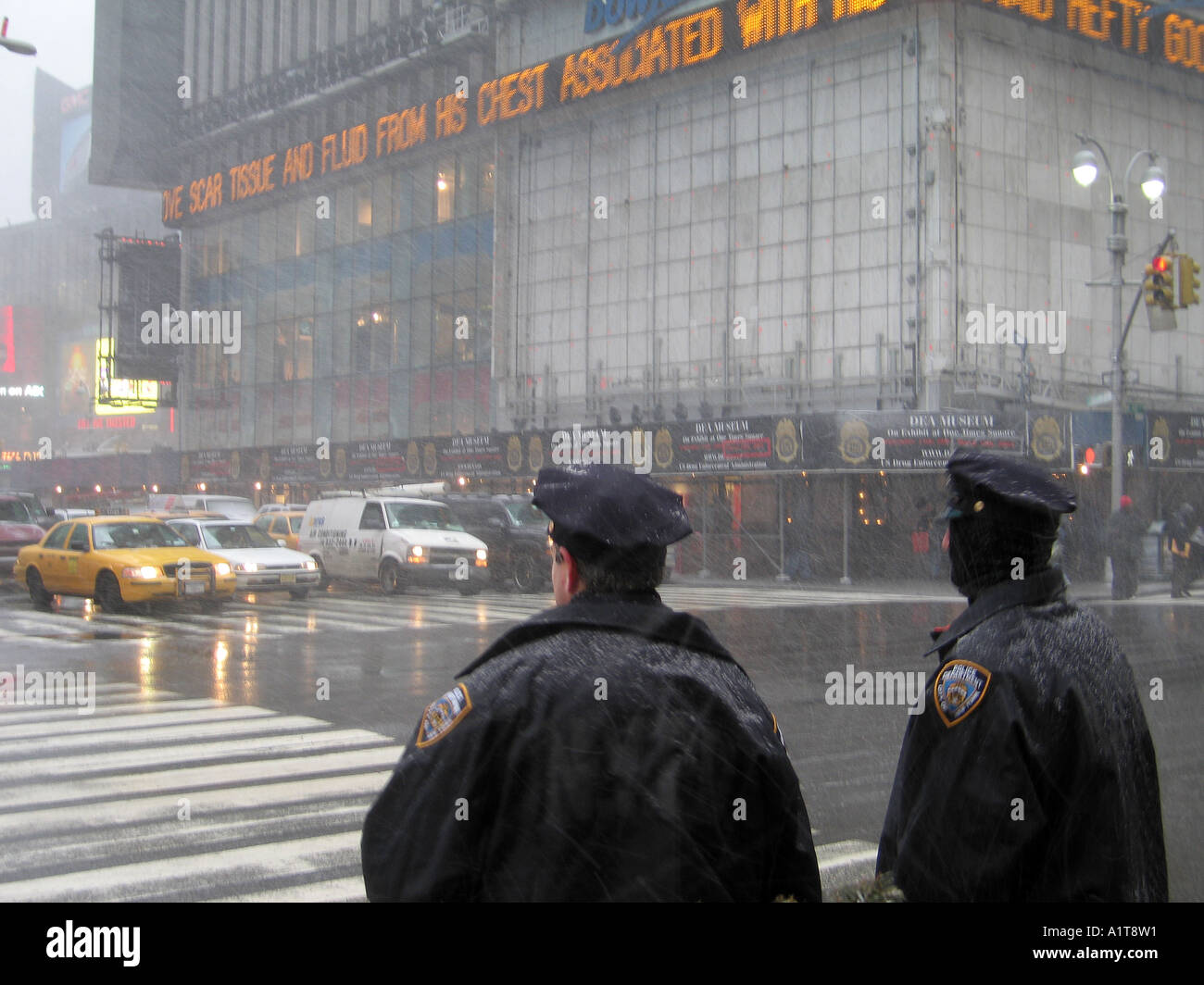 NYPD in front of Times Square buidling, snow falling, NYC Stock Photo