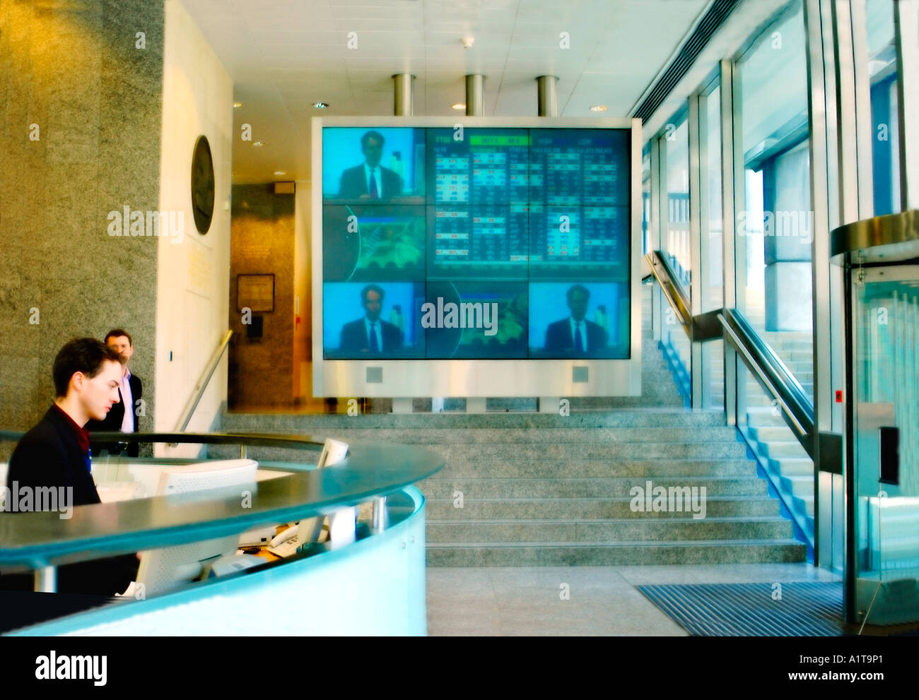 London ENGLAND 'London Stock Exchange' inside view with Receptionist and Television Wall in modern lobby interior Stock Photo