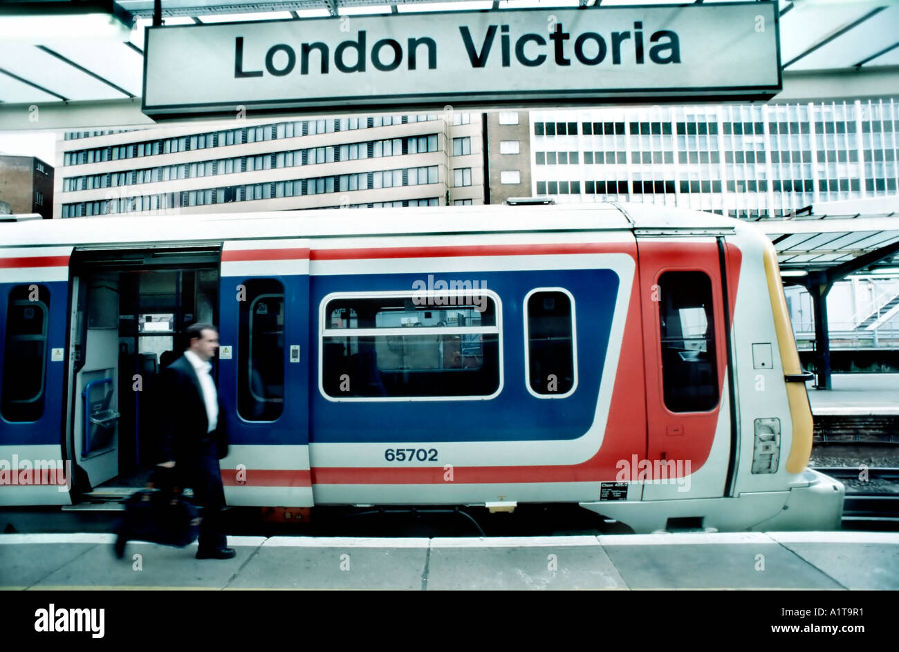 LONDON UK, Businessman walking, Victoria Station 'Connex Train' in Station Business Travel, platform, sign, electric trains Stock Photo