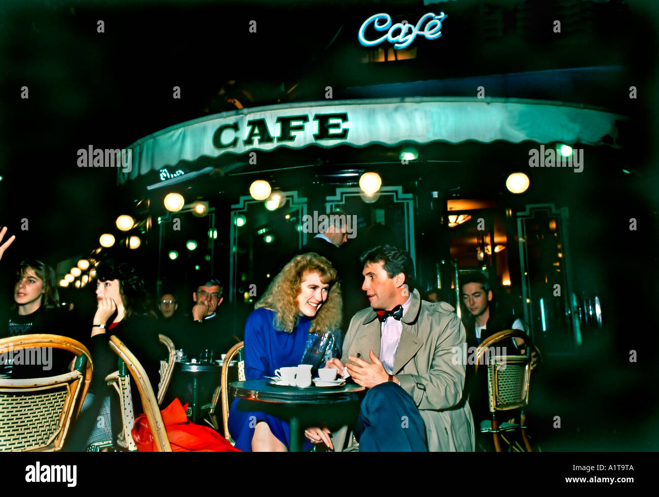PARIS Cafe, France, Couple Sharing Coffee on Terrace of 'Café de Flore' on American Tourists, at night, outdoors, Paris coffee shop old, french cafe Stock Photo