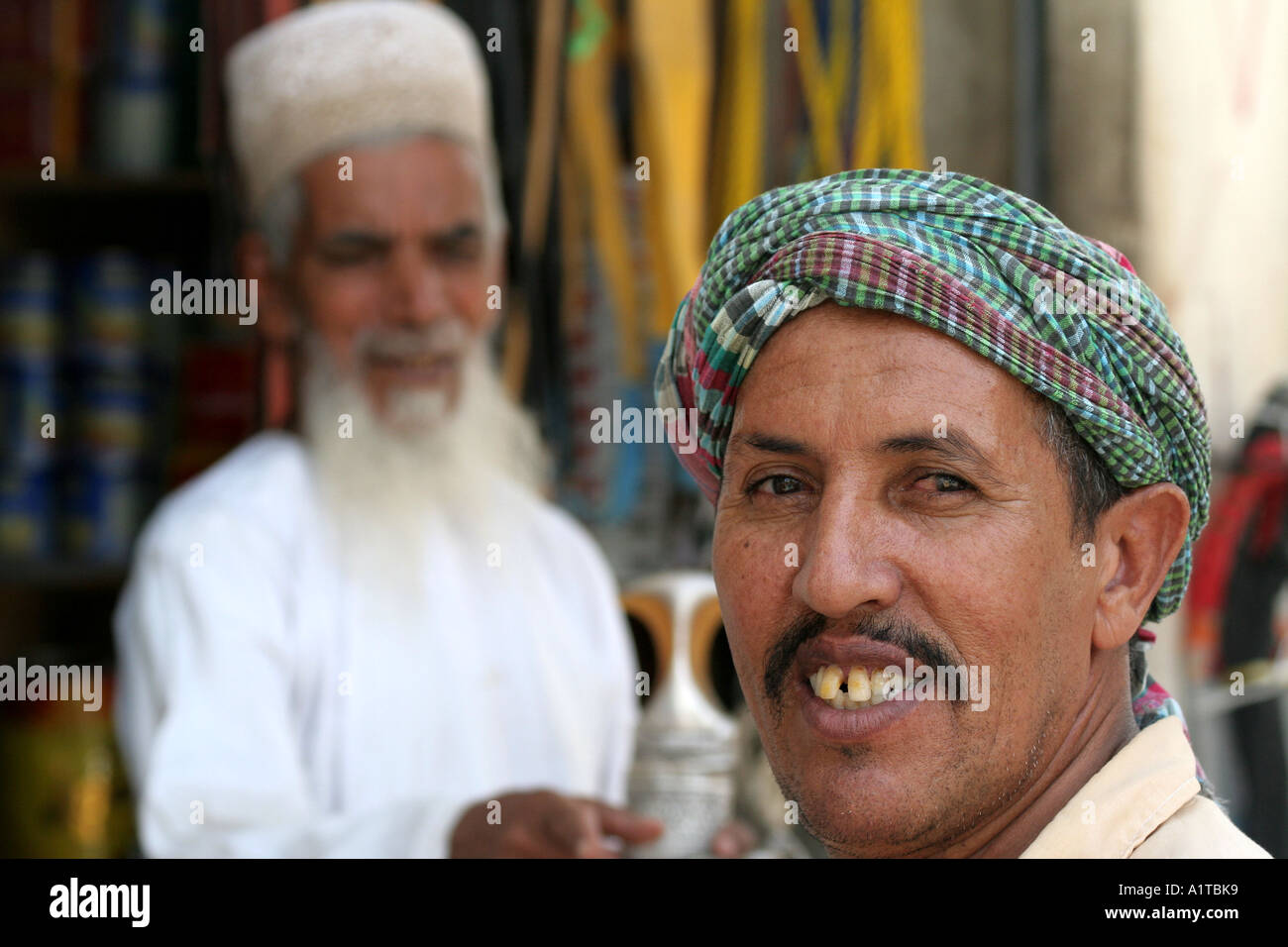 Two Arab Men in Traditional Clothing at the Souq in Sinaw, near Nizwa, Oman Stock Photo