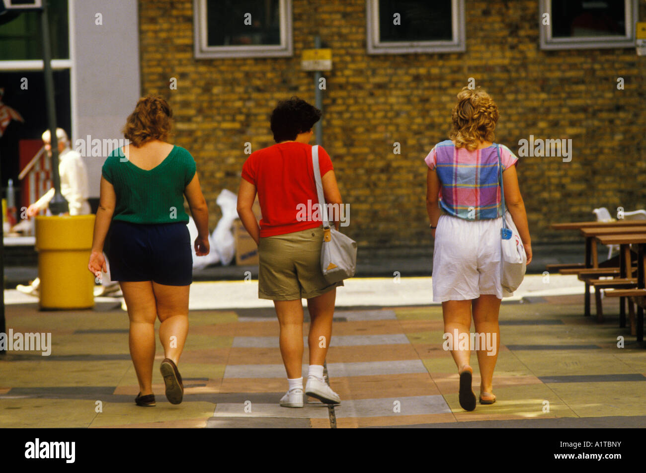 Overweight on holiday three female American tourists in shorts. 1990s circa 1995 London England  UK HOMER SYKES Stock Photo