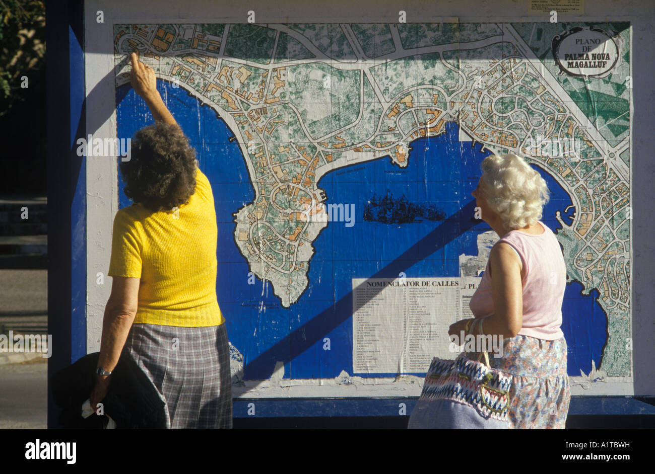 English women on holiday look at a plan of the city of  Palma Nova Magaluf Mallorca Balearic islands Spain 1980s HOMER SYKES Stock Photo