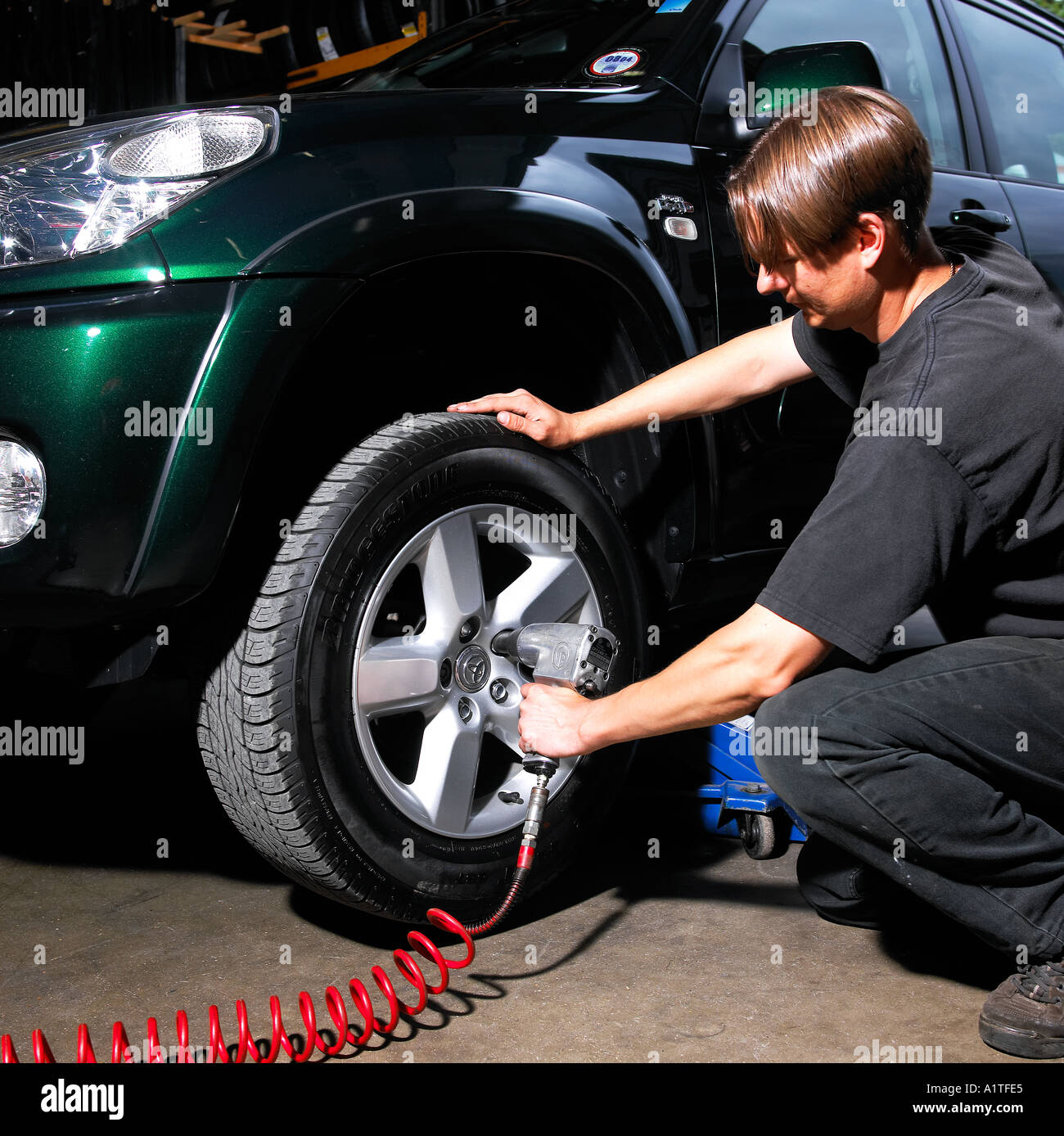 Pneumatic Air Gun tightening wheel nuts Stock Photo Alamy