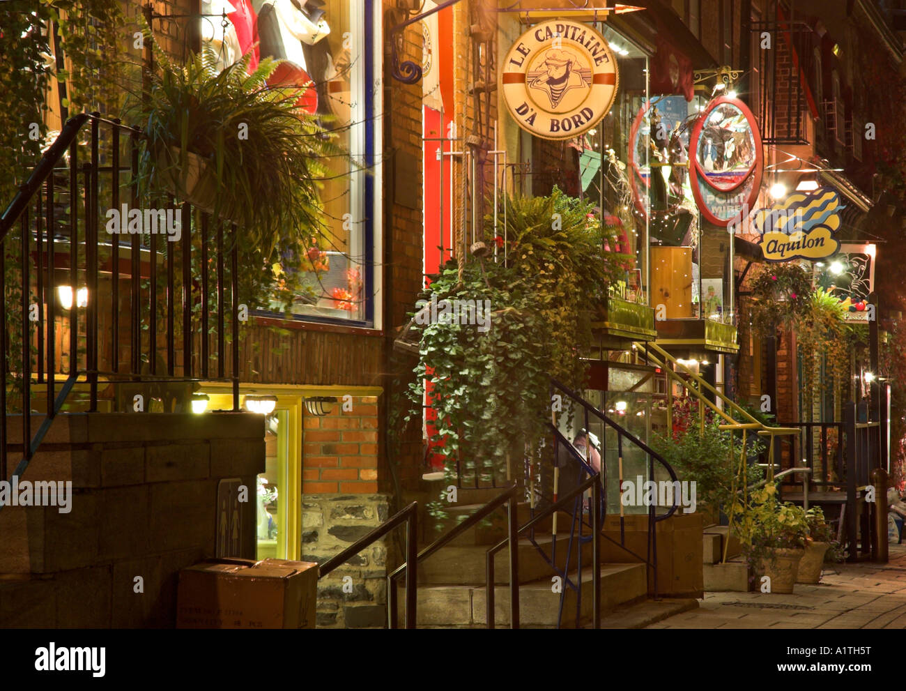 Tourist shops in the narrow cobbled streets of Petit Champlain in old Quebec at night Stock Photo