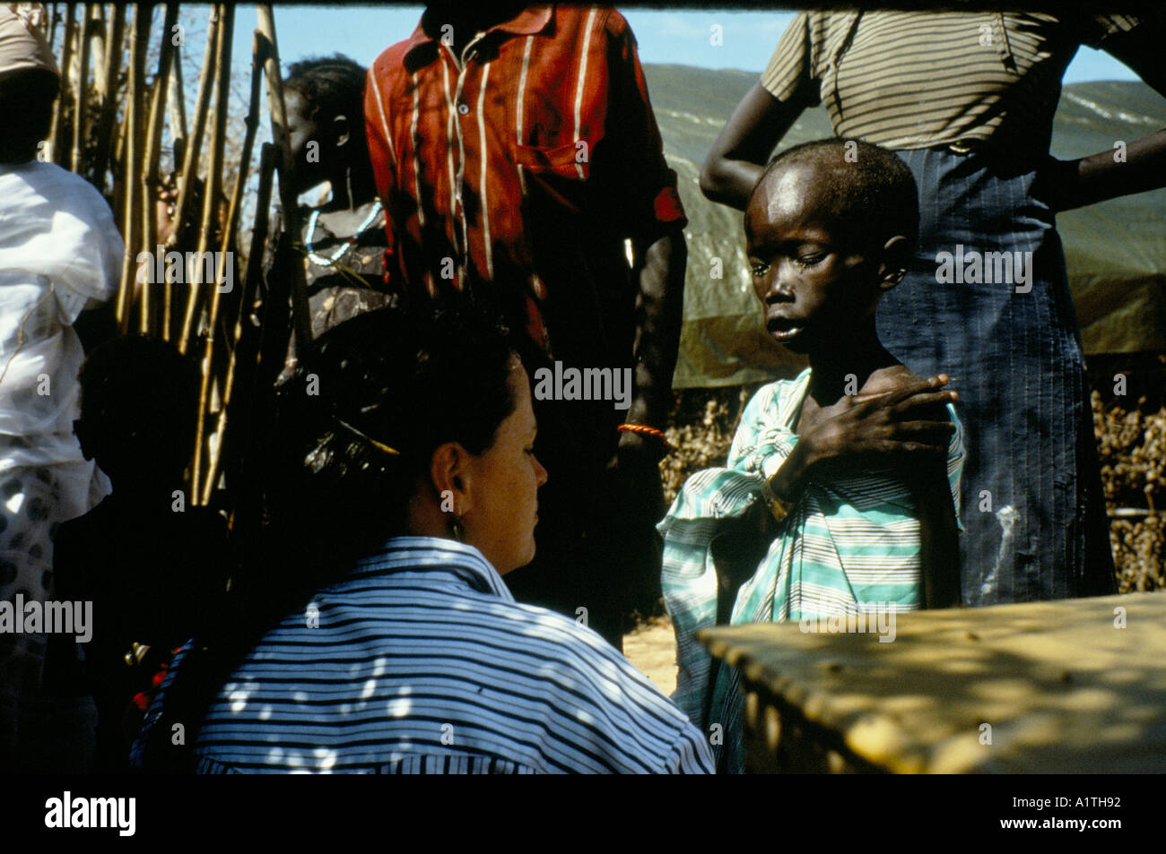 WESTERN MEDICAL AID WORKER WITH CHILD IN EL MUGLAD REFUGEE CAMP SOUTH