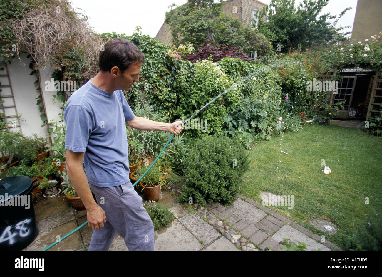 Organic Shopper Goimng GREEN reusing bath water to water garden Stock