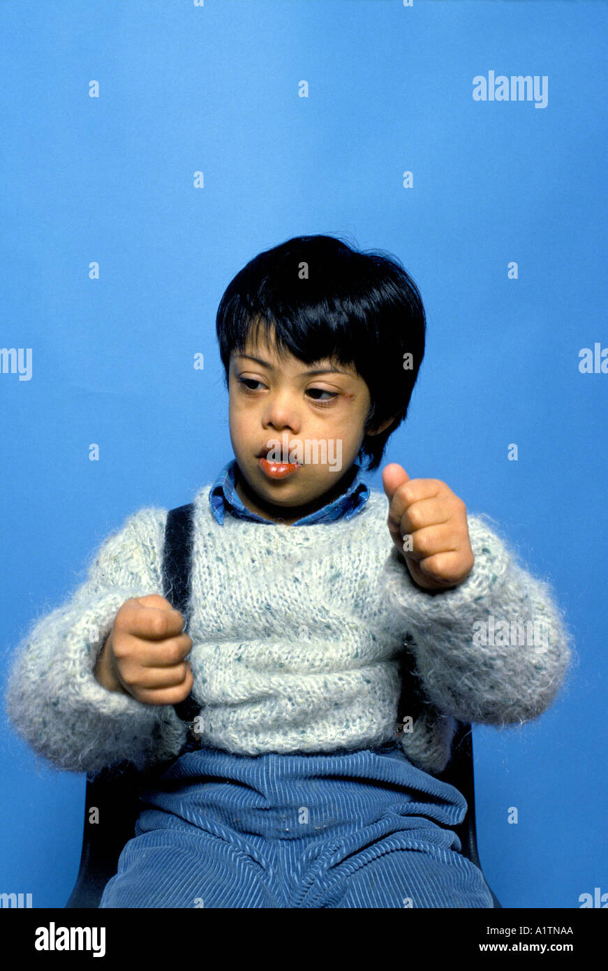 DEAF CHILD USING SIGN LANGUAGE Stock Photo