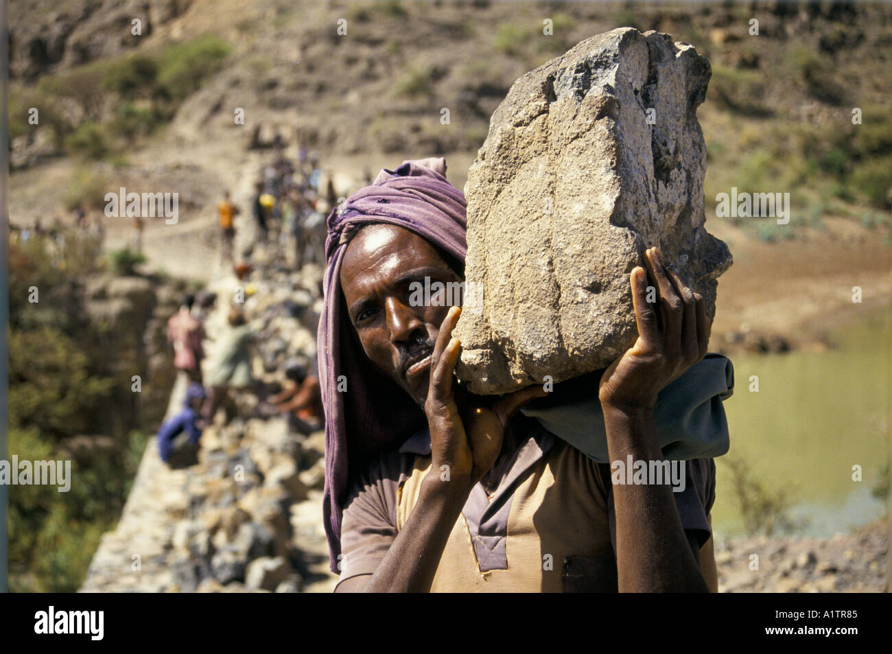Man carrying large stone hi-res stock photography and images - Alamy