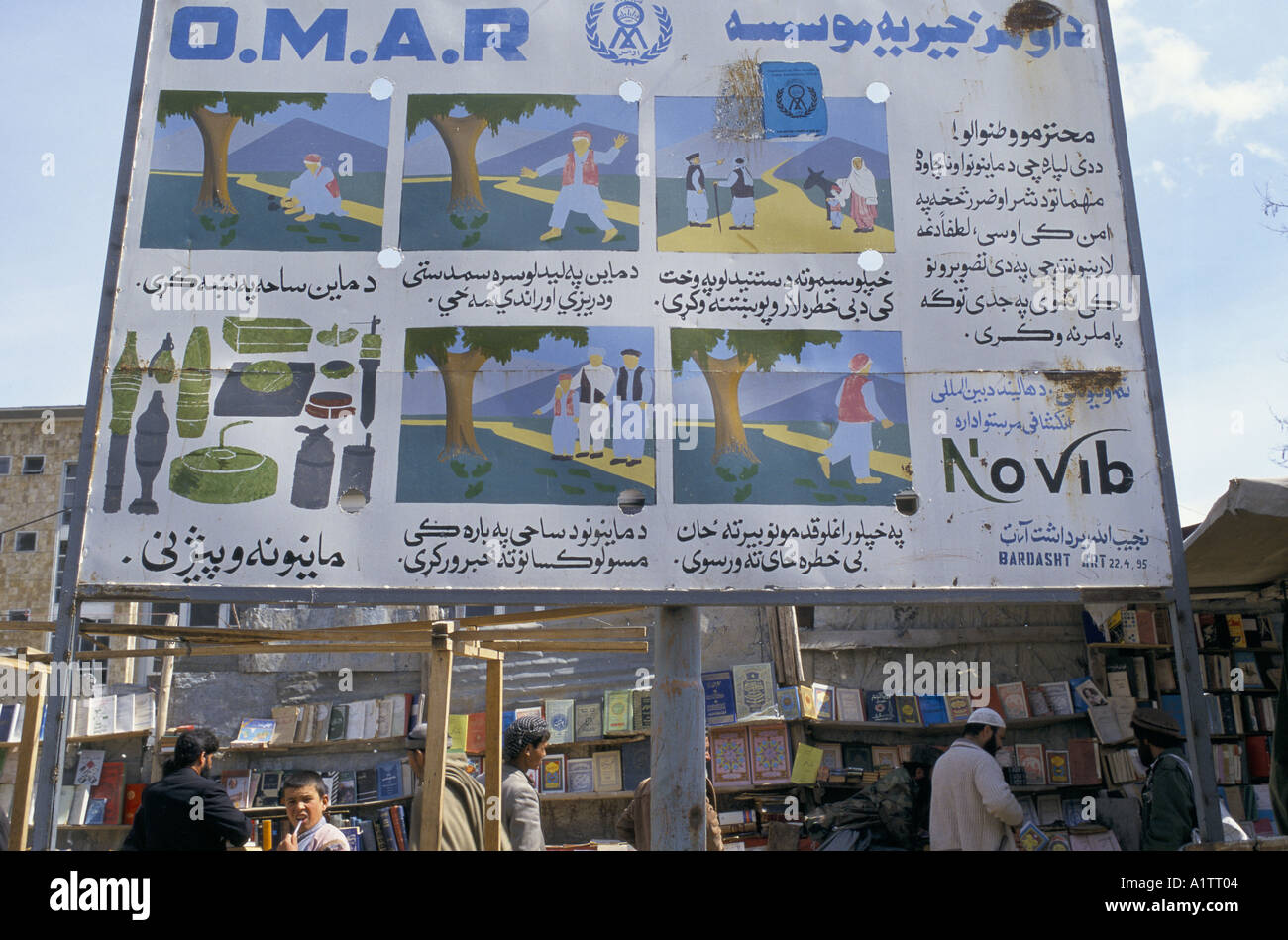 MINES IN AFGHANISTAN . MINE AWARENESS POSTERS IN FRONT OF BOOKSELLERS KABUL 1996 Stock Photo