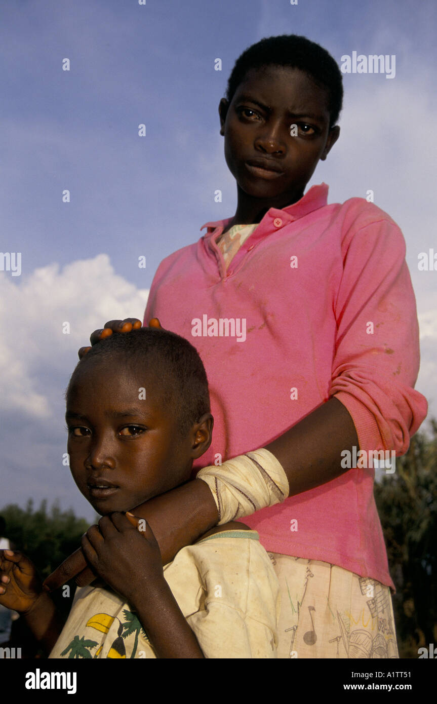 Siblings Rwanda UNACCOMPANIED CHILDREN RWANDA. Sister with bandaged wrist after attack ...