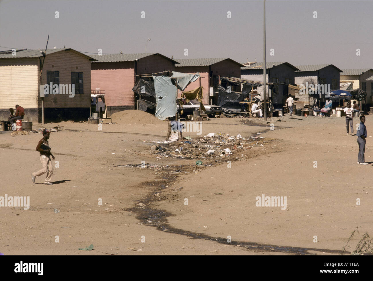 MAN SIFTING THROUGH RUBBISH PEOPLE SITTING TALKING WALKING  KATUTURA TOWNSHIP NAMIBIA Stock Photo