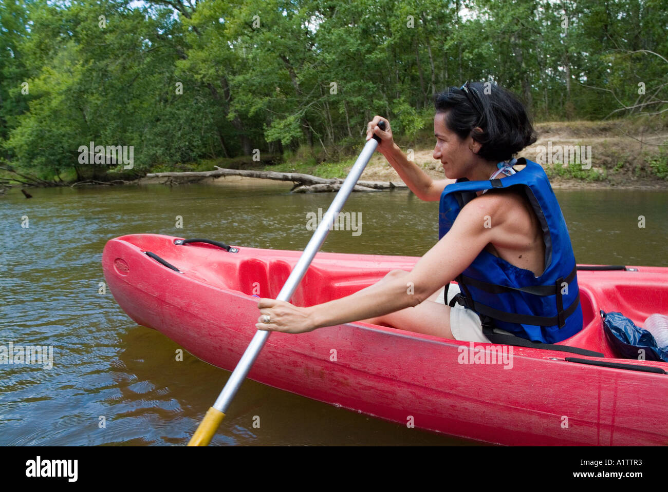 Woman canoeing on the Eyre river, Aquitaine, France. Stock Photo