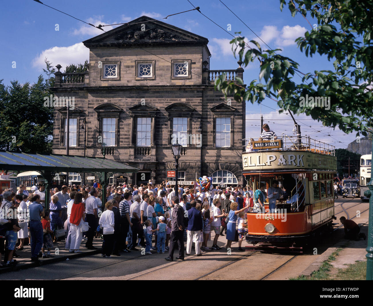 Tourists board a tram in front of the Derby Assembly Rooms building at Crich Tramway Museum near Matlock in the Peak District Stock Photo