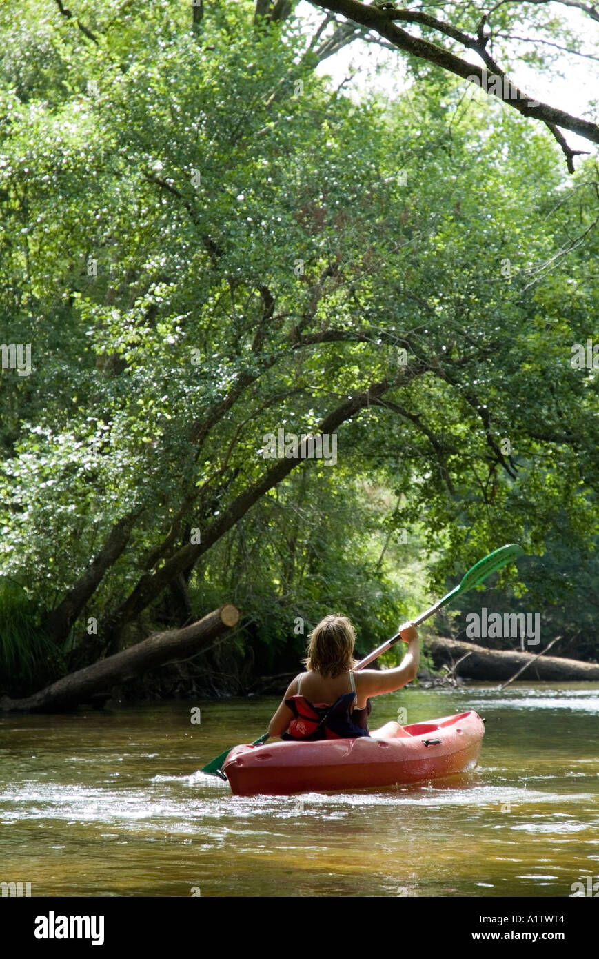 Rear view of a woman canoeing on the Eyre river, Aquitaine, France. Stock Photo