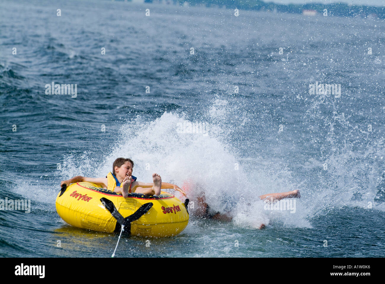 Boy Inflatable Raft Two boys on an inflatable raft in the water Biscarrosse lake in France ...