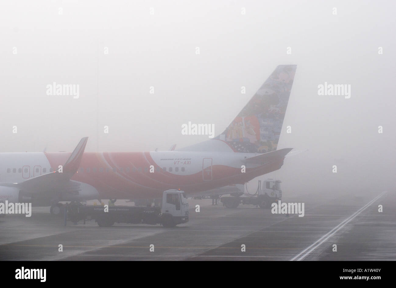 Air India Express Boeing 737 800 aircraft in winter fog at Birmingham International Airport, West Midlands, England, UK Stock Photo