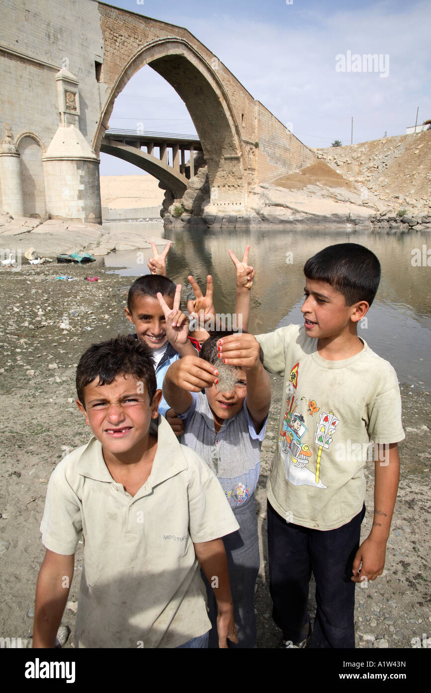 Kurdish boys by Catakkopru bridge. Eastern Turkey Stock Photo