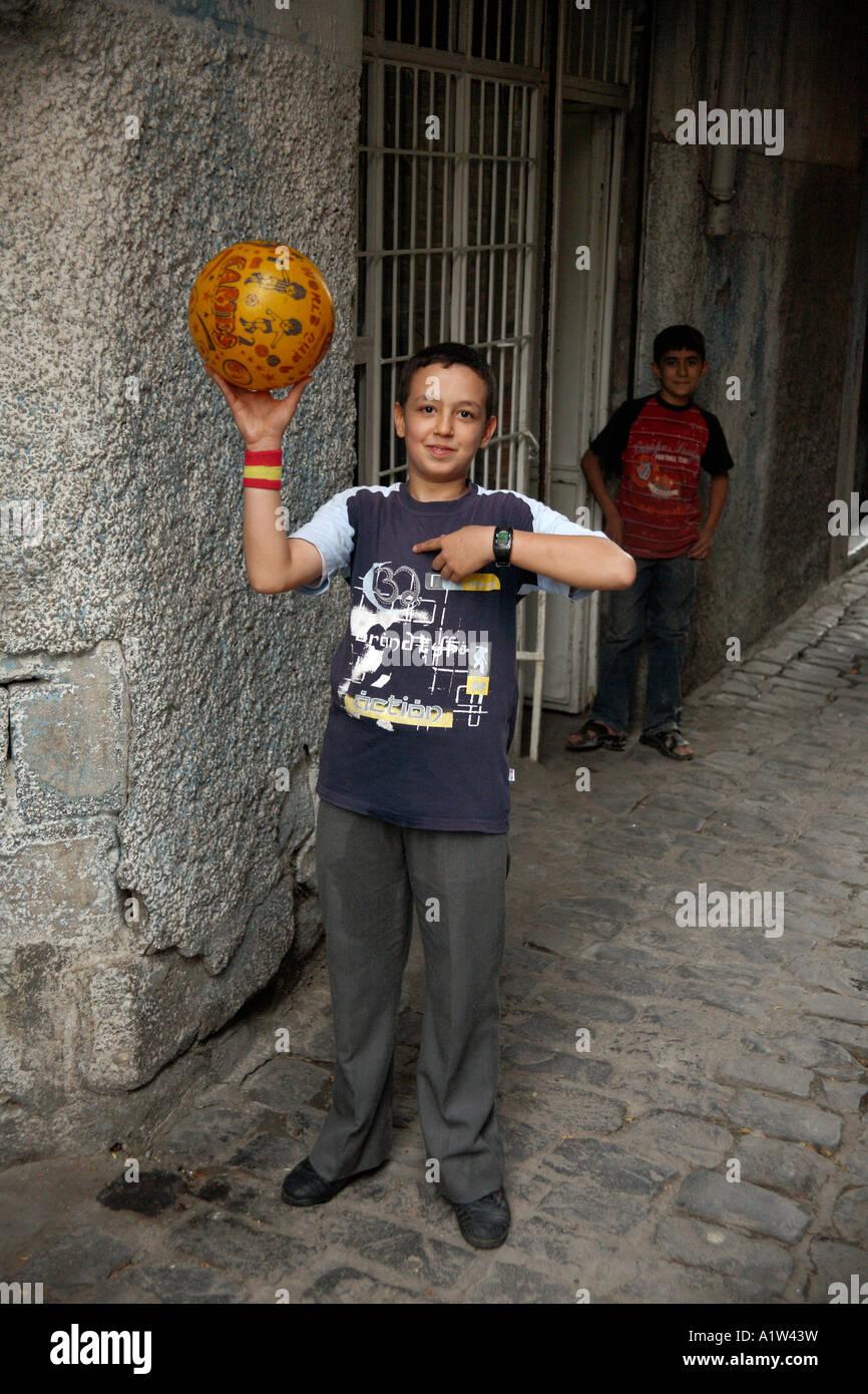 Boy and football in backstreet. Downtown Diyarbakir, Turkey Stock Photo