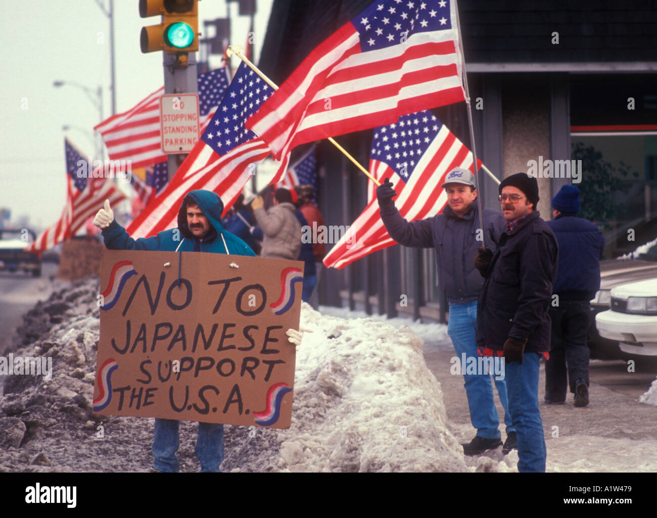 Center Line Michigan Auto workers picket a Toyota dealer waving American flags to protest Japanese imports Stock Photo
