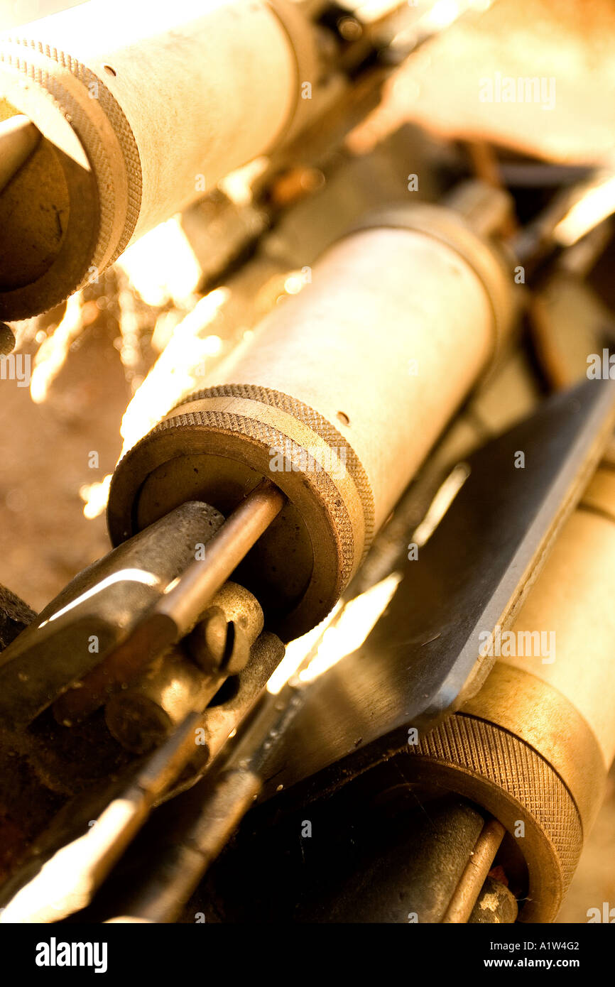 Looks like heavy-duty fuses or capacitors in an industrial setting