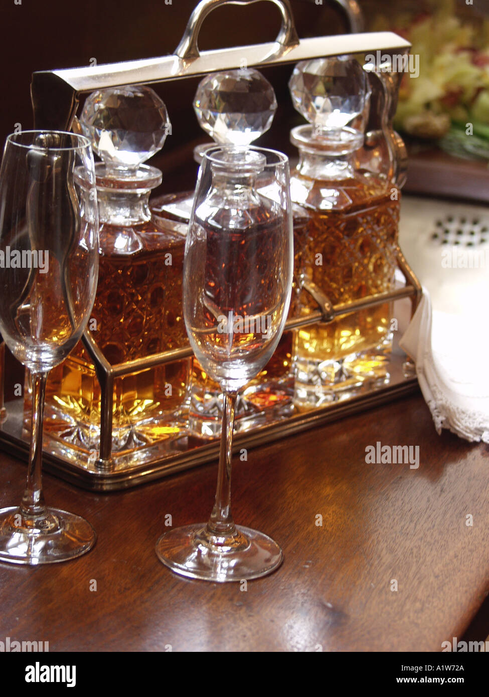 crystal decanters with liquor sitting on wood counter top Stock Photo