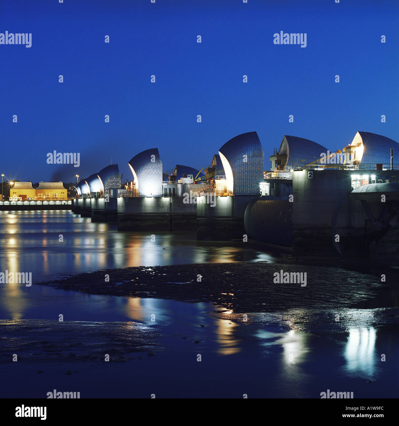Night shot of Thames Flood Barrier at low tide from Silvertown, Newham, London, UK Stock Photo