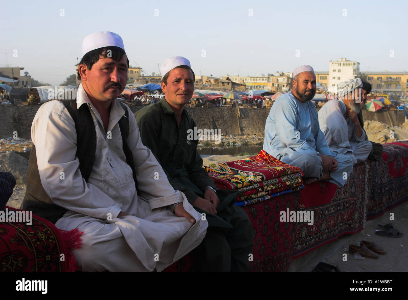 AFGHANISTAN Central Kabul Rug sellers sit on walls of Kabul river Stock Photo