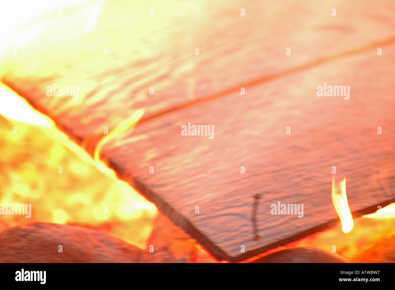 Burning wood with nail Stock Photo Alamy