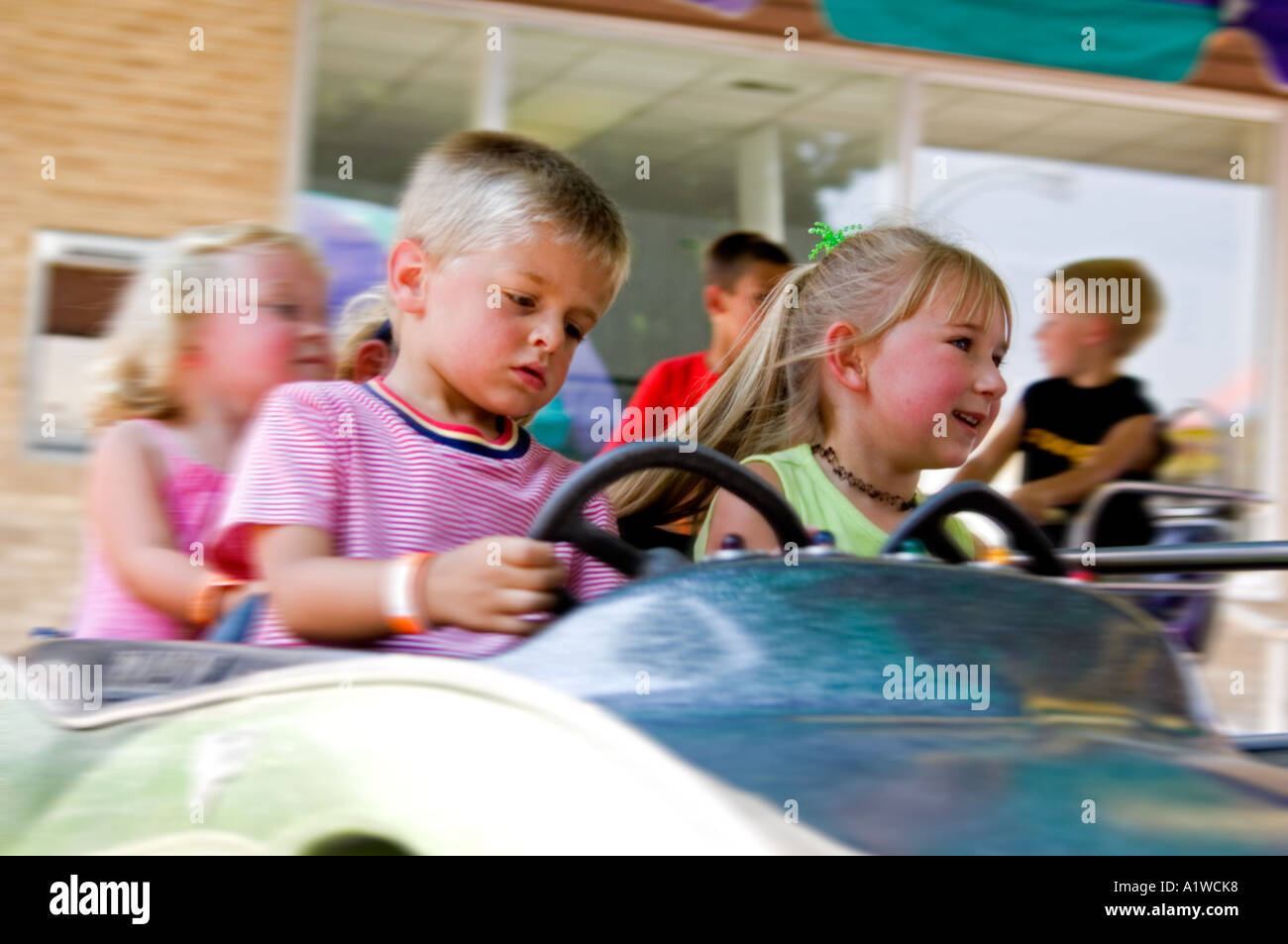 Kids on carnival ride Stock Photo - Alamy