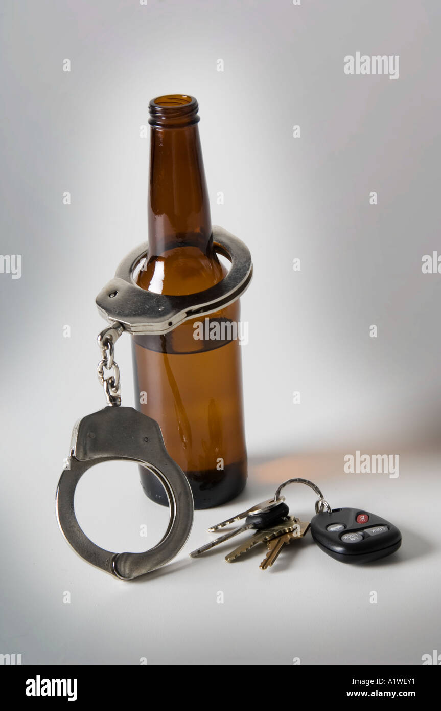 Beer bottle car keys and handcuffs Stock Photo Alamy