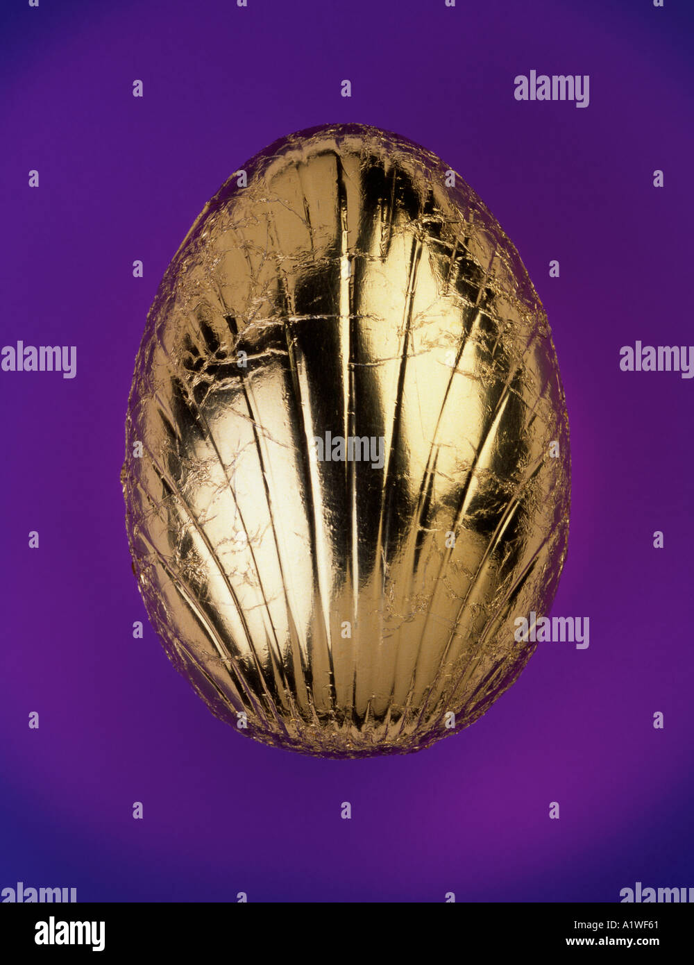 Chocolate Easter egg covered in gold foil Stock Photo