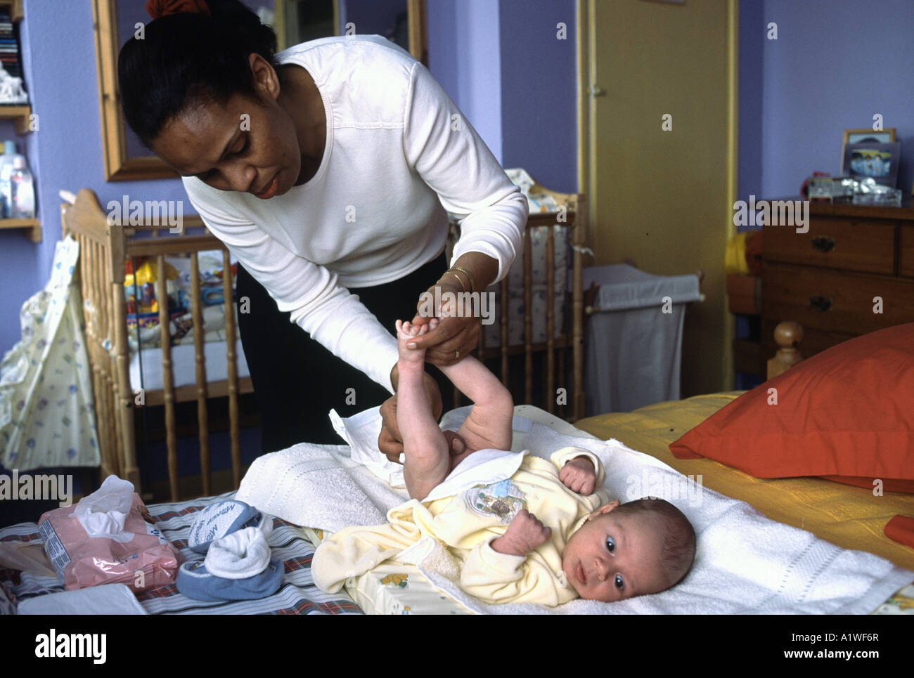 Mother changing baby's diaper Stock Photo Alamy