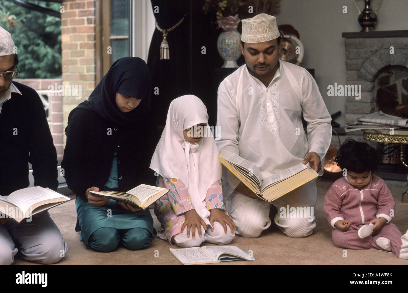 Muslim family praying in the home at end of Ramadam Stock Photo
